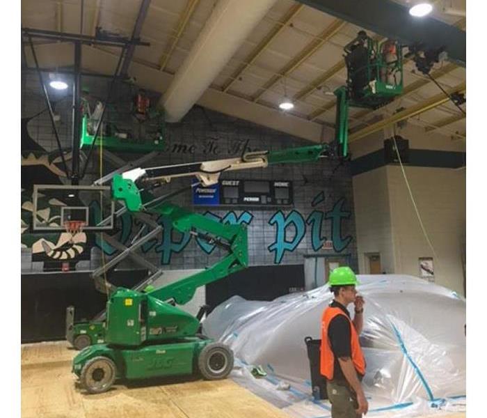 SERVPRO technicians restoring water damage in a gymnasium in Forsyth, GA.